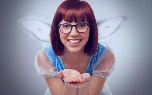 A woman dressed as a fairy holding a pearl, spreading oral hygiene tips to make the tooth fairy proud.