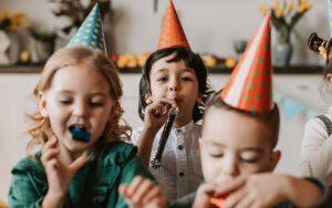 A group of children having fun with braces and blowing bubbles.