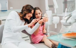 A dentist showing a preventative-bradford-dental-care-for-kids-best-family-dentist-near-me